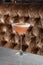 Orange Clover Club Cocktail in Coupe Glass with Layer of Foam and orange chips Garnish isolated on dark Background.