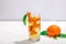 Orange cocktail with ice and ripe fruits. Refreshment seasonal drink, conceptual background