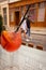 Orange cocktail on table with unfocused people on background. Aperol spritz cocktail on table. Drinks in outdoor bar. Summer party