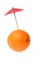 Orange with coctail umbrella isolated on white