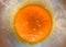 Orange color fluid of yolk stir in bowl