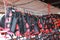 Orange color life jackets hanging in the row on boat station