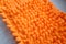 Orange color microfiber cleaning material texture, closeup shoot.