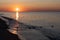 Orange color sunrise over tranquil seascape with buoys in water