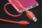 Orange color USB cable and red power bank