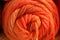 Orange colored macro of a spool of yarn