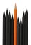 Orange colored pencil among black simple