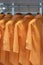 Orange colors shirts hang in a wooden closet at modern home decoration