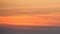 Orange colors sunset. Background abstract image of the sky in warmth colors during the sundown with horizontal light clouds
