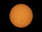 The orange coloured afternoon sun glowing with many sunspots using a homemade solar filter.