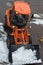 Orange-coloured Snowplough Operating on the Road