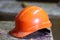 Orange construction helmet in the workplace close-up