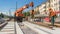 Orange construction telescopic mobile crane unloading tram rails from truck timelapse.