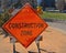 Orange construction zone sign on barricade