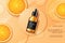 Orange cosmetic. Product ad banner. Skincare liquid serum on beauty glass bottle display. Tangerine fruit composition