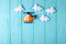 Orange craft helicopter and clouds on blue wooden background with copyspace. Felt handmade toys. Empty space for text. Top view.