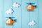 Orange craft helicopter and clouds on blue wooden background with copyspace. Felt handmade toys. Empty space for text. Top view.