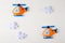 Orange craft helicopter and clouds on white wooden background with copyspace. Felt handmade toys. Empty space for text. Top view.