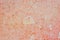 Orange creased watercolor painted paper background texture