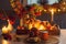 orange cup of tea and autumn decor with pumpkins, flowers and burning candles on table