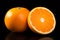 An orange and cut orange, in the style of vibrant sensations, clear and crisp