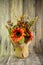 Orange decorative sunflower and two acorns isolated on the wood background. Thnksgining content