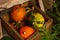 orange decorative ugly pumpkins in a wooden box