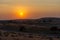 Orange desert sunset across the sand dunes in Ras al Khaimah, United Arab Emirates near Dubai. Luxury Travel