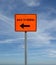 Orange detour construction sign with Back To Normal text and arrow and blue sky