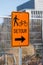 Orange detour sign for cyclists and pedestrians. Closed way.