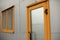 Orange door to building. Entrance to office. Door with glass