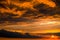 Orange dramatic cartoon cumulus clouds at sunset