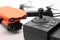 Orange drone with camera and remote control