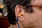 Orange earplugs in the ear in humans to reduce noise .