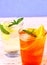 Orange, elderflower cocktails on blue background
