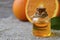 Orange essential oil in a glass bottle for skin care, spa, wellness, massage, aromatherapy and natural medicine.