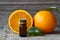 Orange essential oil in a glass bottle for skin care, spa, wellness, massage, aromatherapy and natural medicine.