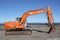 Orange Excavator on the Beach