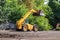 Orange excavator on wheels, earthmoving machinery for construction and earthworks
