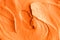 Orange facial mask pumpkin cream, body scrub texture close up. Abstract background