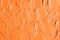 Orange facial mask pumpkin cream, body scrub texture close up. Abstract background, brush strokes