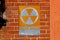 Orange `Fallout Shelter` sign on a brick wall I