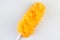 Orange feather duster with a plastic handle