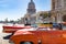 Orange fender of american classic cars in front of Capitolio, Havana, Cuba