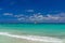Orange ferry in azure ocean with swimming people in Playa del Carmen, Yukatan, Mexico