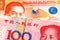 Orange Filipino money close up with red money from China
