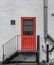 Orange fire door seen at the side of offices in central London.