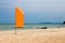The orange flag on beach, sea background