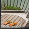 Orange flip-flops lying at a house entry