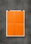 Orange folded poster hanging on a concrete wall with clips